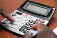 Closeup of person using calculator