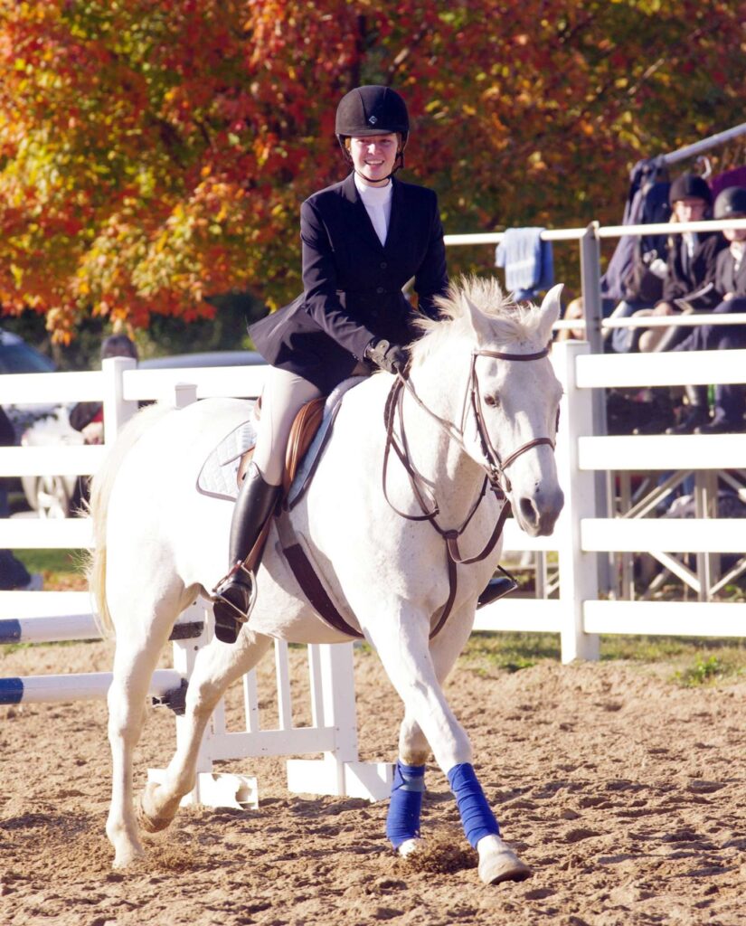 Equine student riding a horse