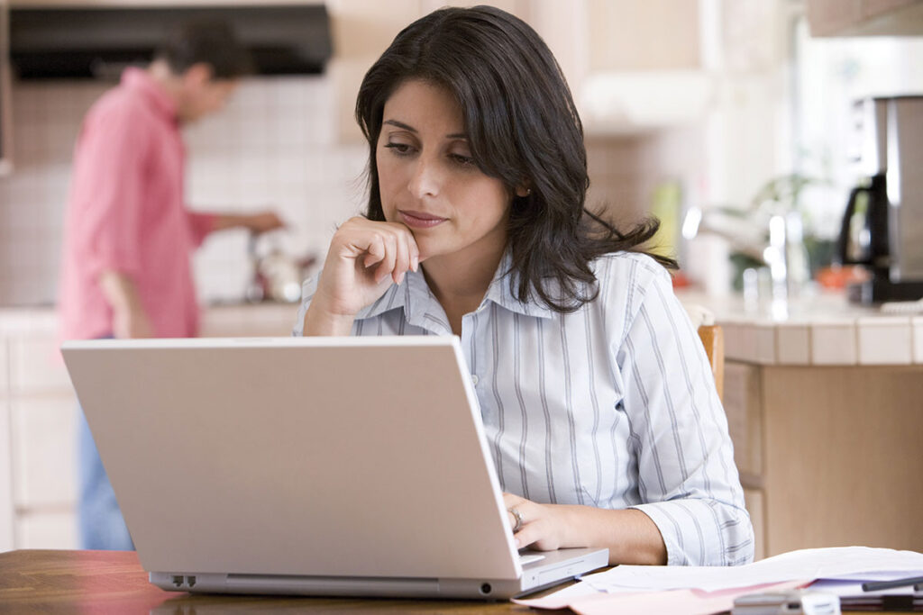 Woman using computer at home