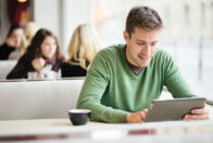 Guy on iPad in cafe