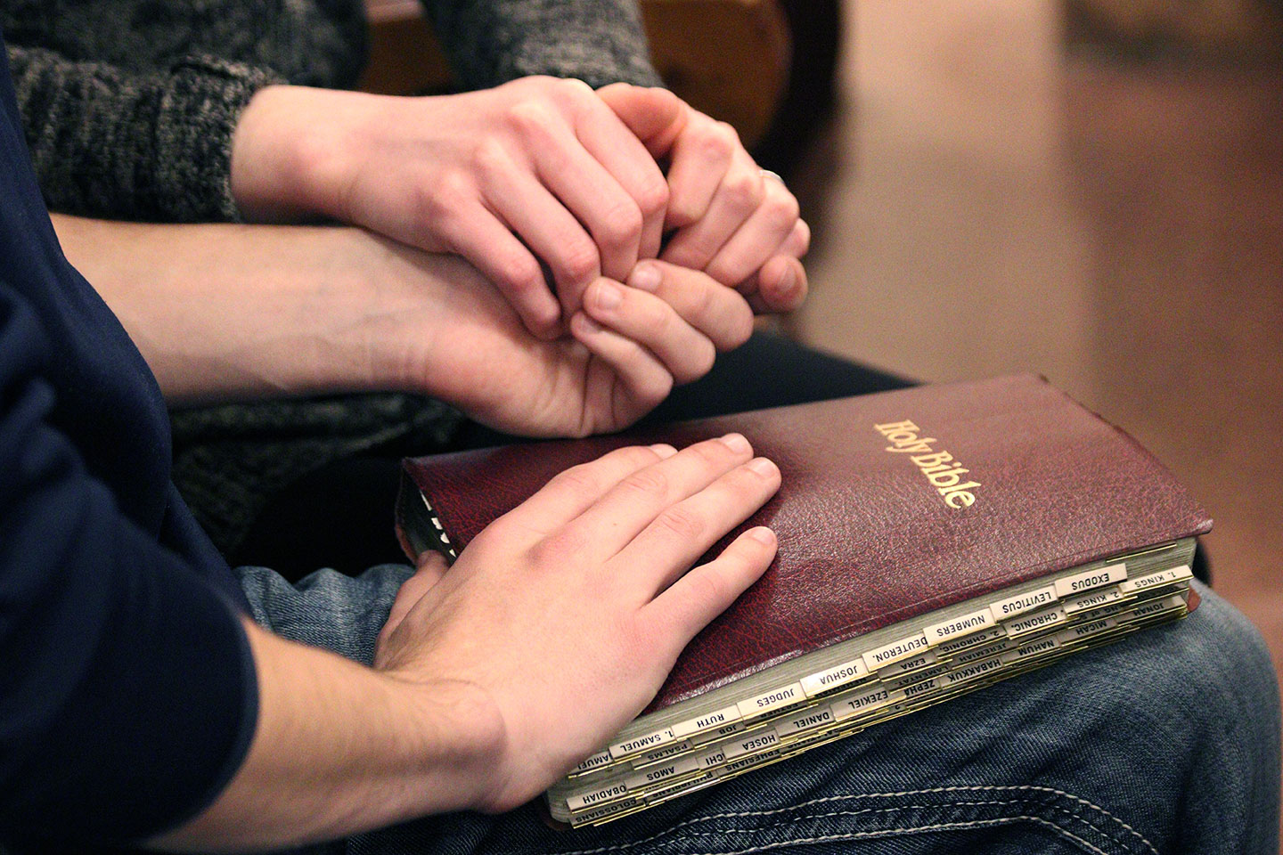 praying with hand on bible