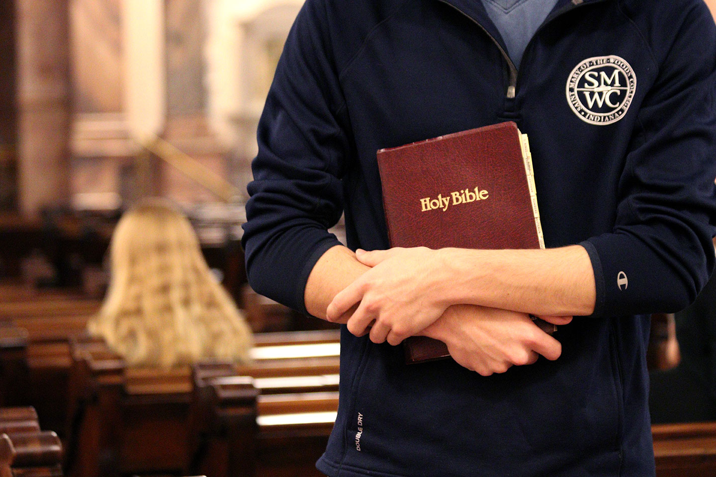 student holding bible