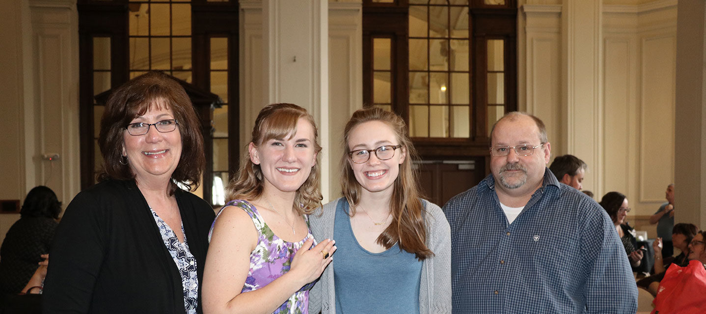 Student posing with her family