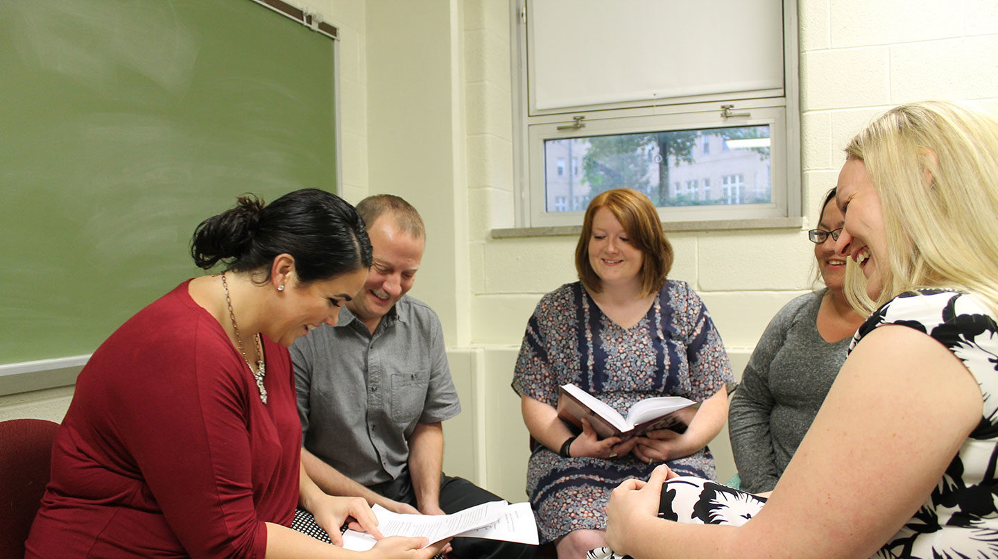 graduate students talking and reading