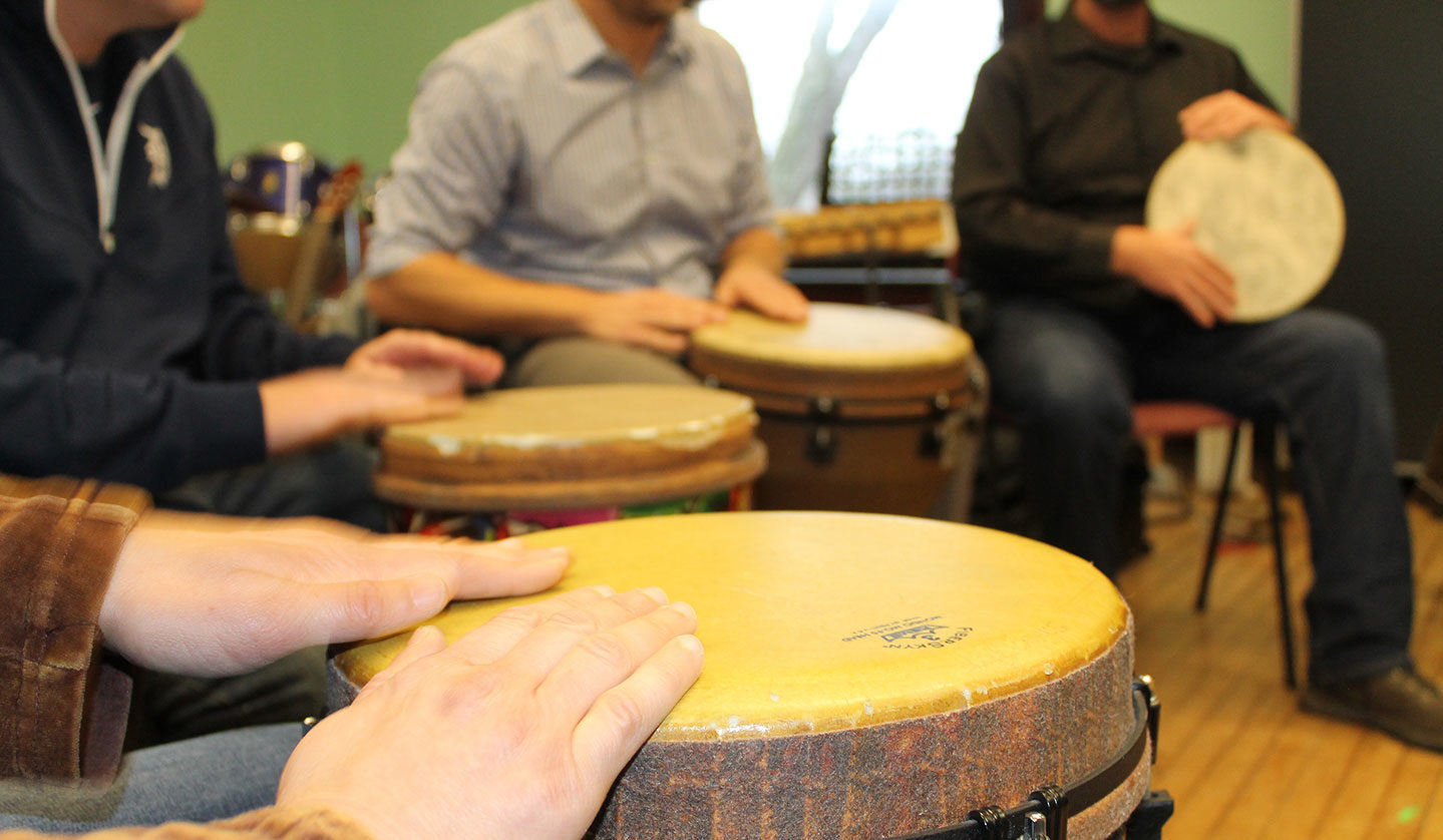 closeup of students playing drums