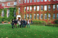 Students walking in front of a building in England