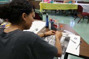 graduate student working on magazine collage