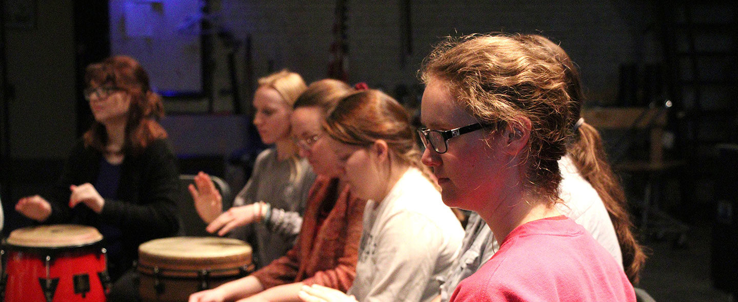 Students participating in a drum circle