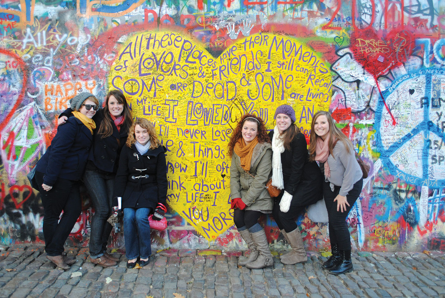 Students posing with graffiti art