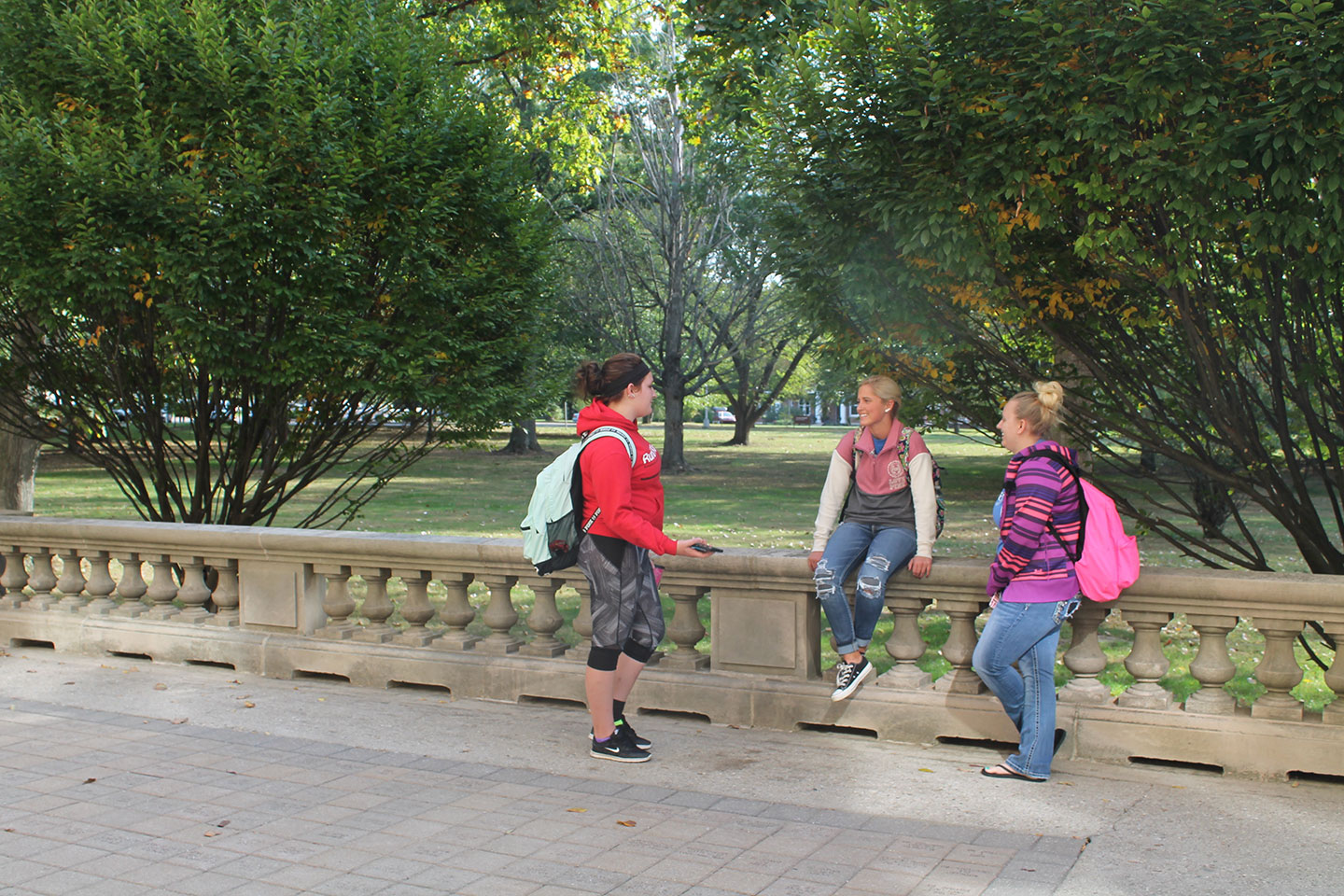 Students talking on the porch of Guerin Hall