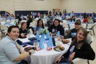 Students eating in the auxiliary gym