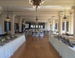 The ballroom set up for an event with buffet tables