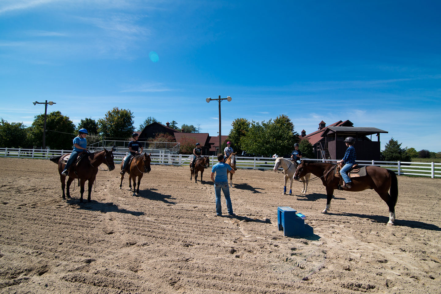 Students on horses with equine professor