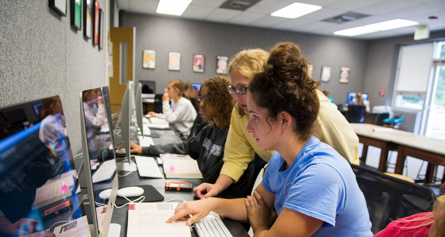 Professor helping student on the computer