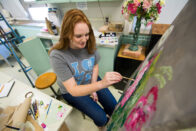 Student painting flowers