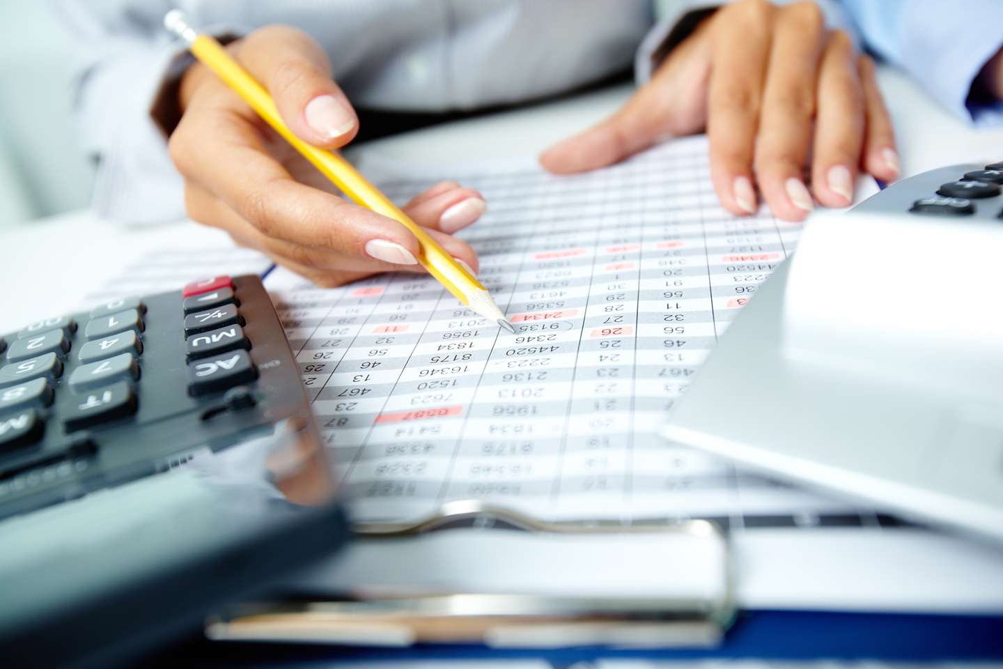 Calculator and woman holding pencil