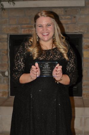 Emilee Robers holding her award