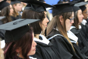 Row of graduates sitting at commencement