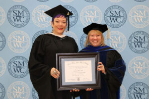 Stephanie Wray standing with President King holding award