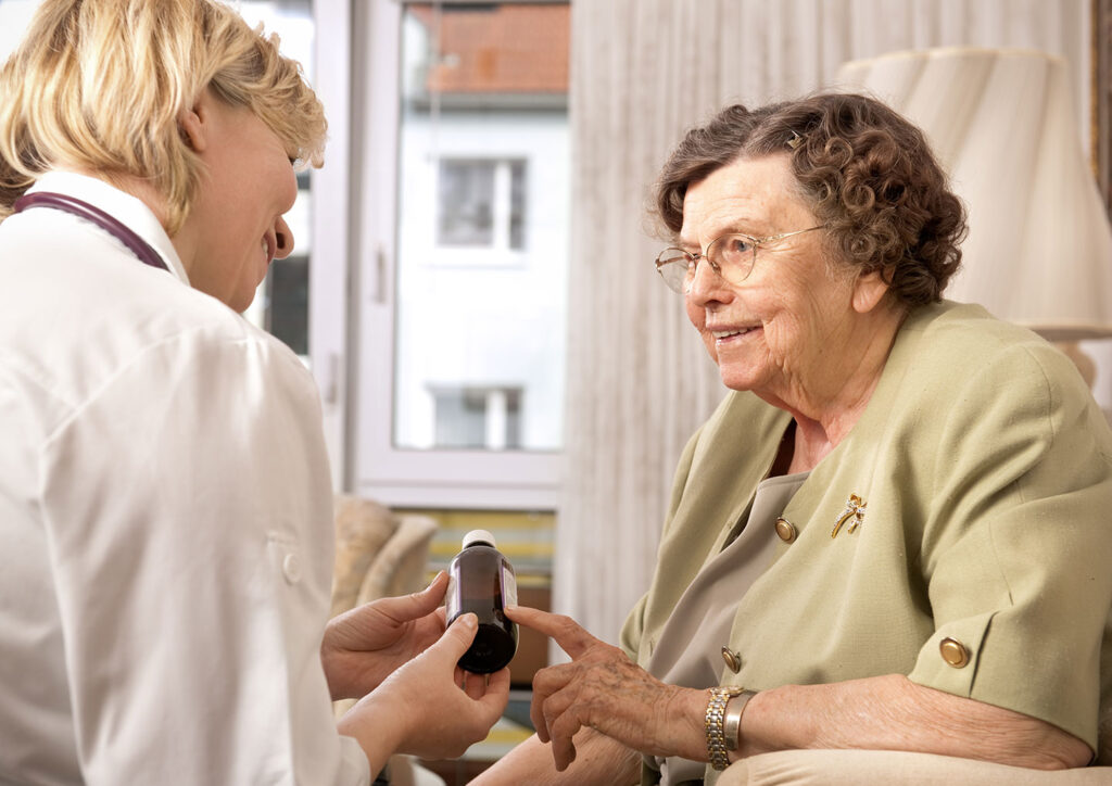 Nurse explaining prescription to elderly patient