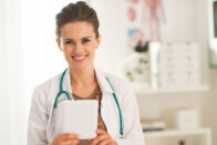 Young nurse standing smiling in clinic