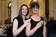 Madeline and Valerie Grumieaux posing with Woods Rings at the reception