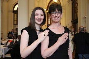 Madeline and Valerie Grumieaux posing with Woods Rings at the reception