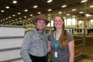 Kendall Dudenfoeffer standing next to Chris Cox in arena