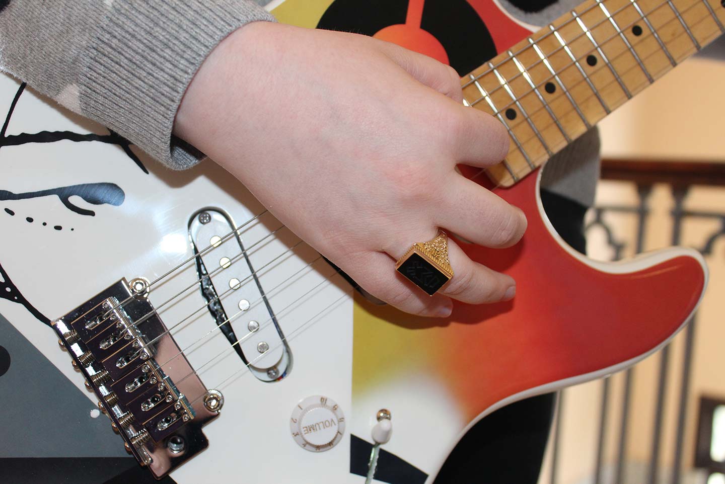 Closeup of student playing one of the custom-built guitars
