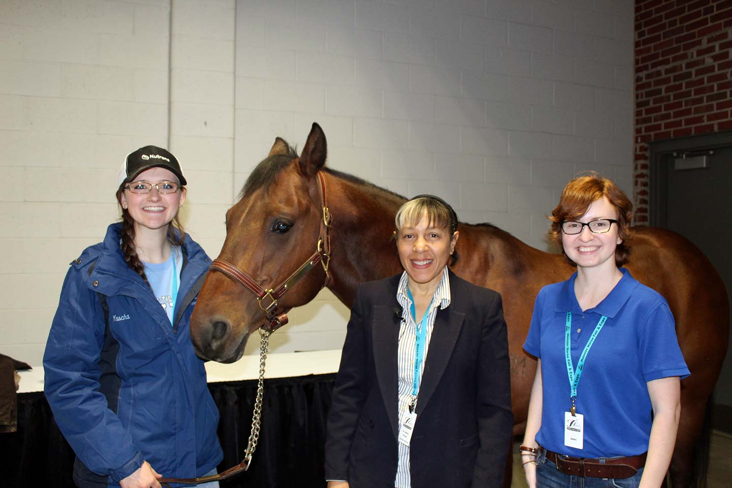 Group of students and faculty stand with horse at the Hoosier Horse Fair