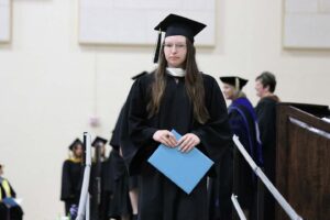 Audrey Dixon walking down the ramp from the commencement stage