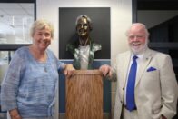 Gail and Jerry McKenna standing next to the bust