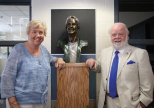 Gail and Jerry McKenna standing next to the bust