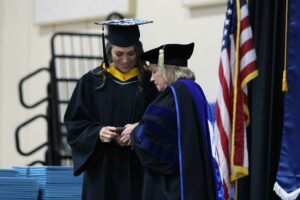 President King hands Madeline Nicole Howes the medal