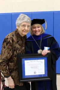 Dorthy Weinz Jerse standing with President King holding the award.