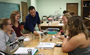 Tarasi showing group of students measurement on scale in a classroom