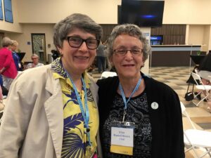 Maroni and Brown smile broadly standing together in the Ariens Atrium