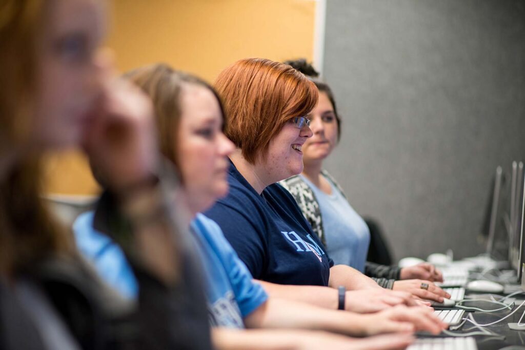 Smiling student working in the design lab