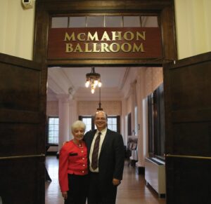 Anita and Michael McMahon stand in the doorway of ballroom.