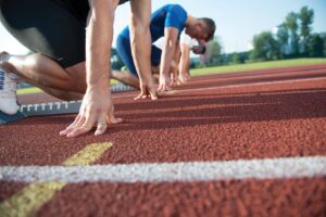 Men line up on running track for a race.