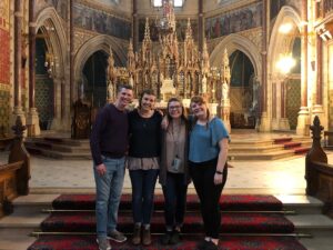 Boswell, Payonk, Burns, and Sonderman stand in front of the altar at Maynooth University Chapel