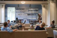 Students sitting in the middle of Sullivan Parlor smile and talk.