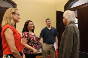 Music faculty talking with Ron Oates at the Conservatory of Music at SMWC