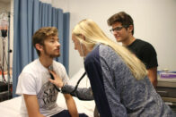 Loebker and Turner testing stethoscope on Nuest during class exercise.