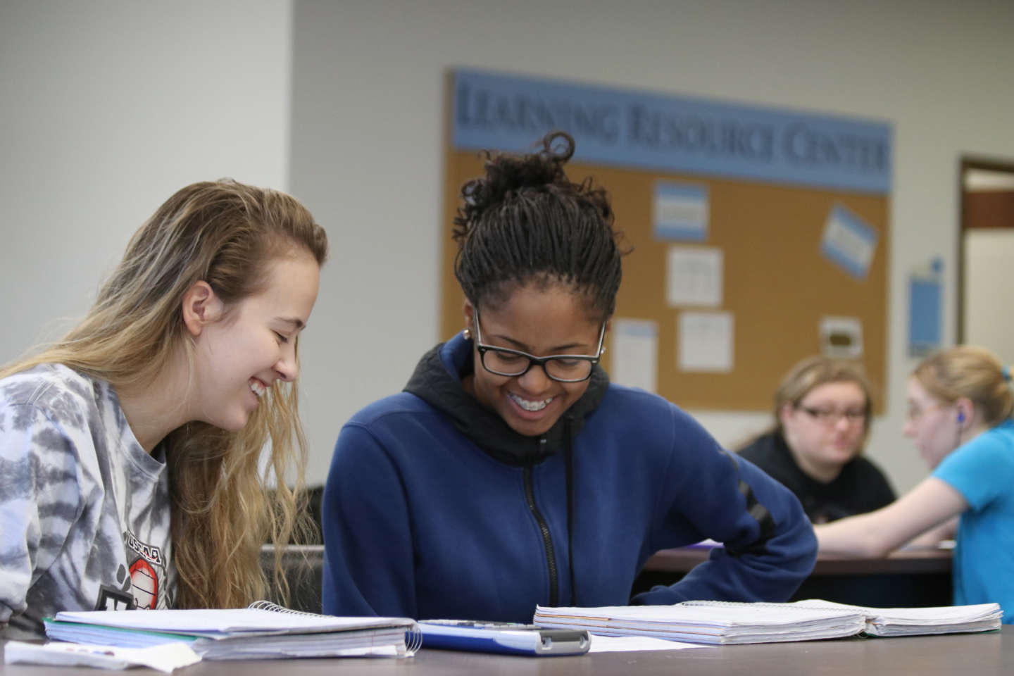 Student mentors helping SMWC students with homework at the LRC