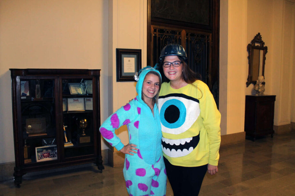 Students wearing matching Monsters Inc. costumes hug after a Big/Little reveal