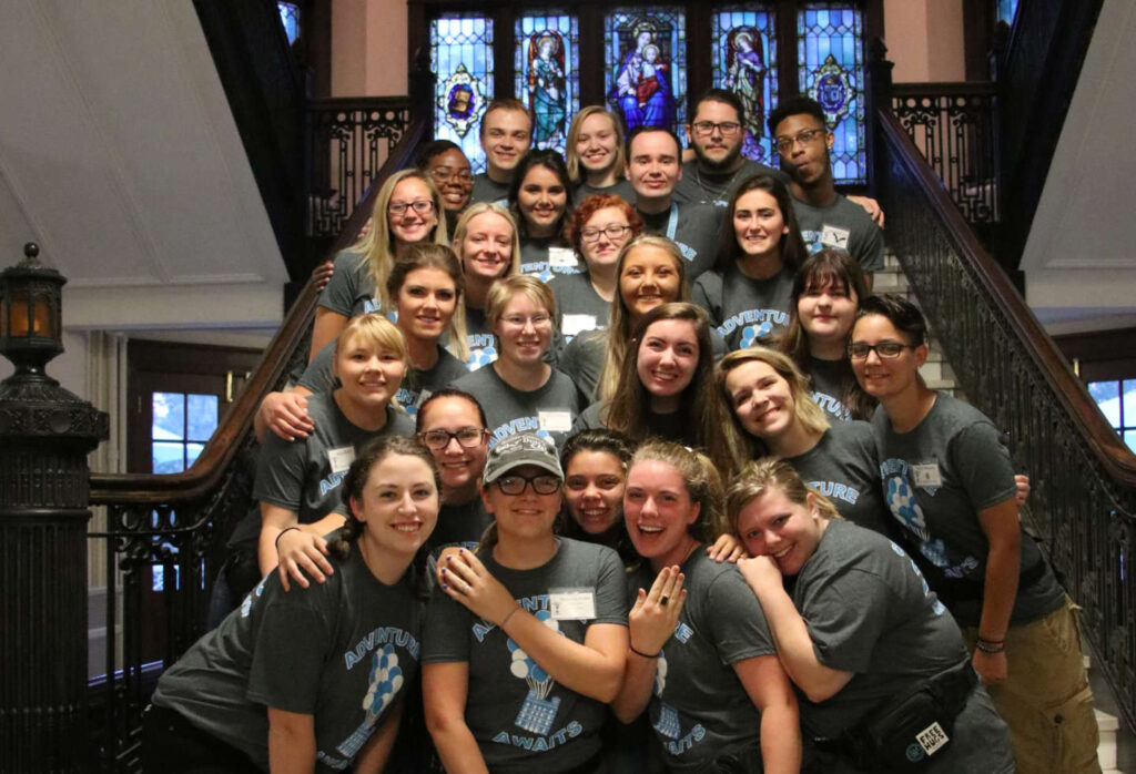The 2018 OLs stand on the main stairs in Le Fer hall for a group photo