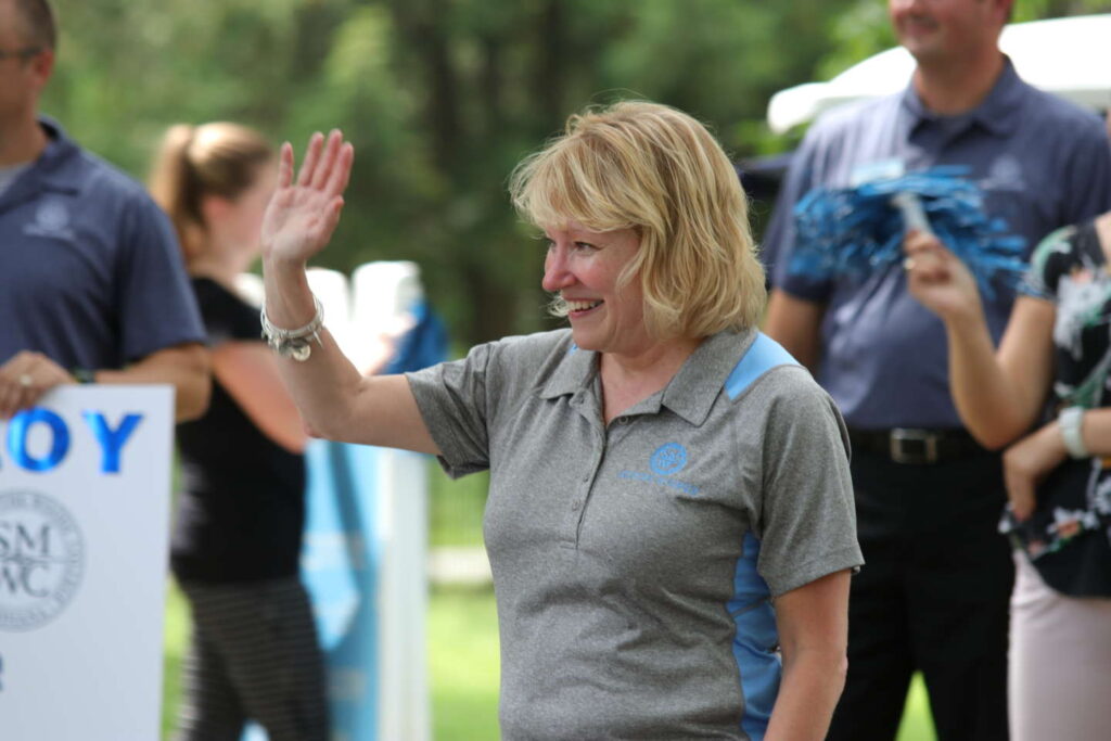 President King waving to new freshman on move-in day.