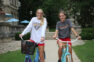 Smiling students sitting on bikes in front of Guerin Hall