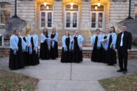 Group photo of the Madrigals on the front porch of the Conservatory of Music.